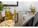 Close up of well-stocked home bar featuring drinks, snacks, and playing cards; perfect for entertaining at 572 Commonwealth Ln, Sarasota, FL 34242