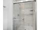 Walk-in shower with glass door and marble tiling and built in shelves at 572 Commonwealth Ln, Sarasota, FL 34242