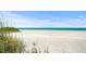 Beautiful white sand beach with clear turquoise water and scenic dunes nearby at 572 Commonwealth Ln, Sarasota, FL 34242