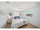 Bright bedroom with a ceiling fan, light blue walls and light hardwood flooring at 572 Commonwealth Ln, Sarasota, FL 34242