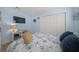 Bedroom with blue walls, a ceiling fan, white closet, and nautical themed decor at 572 Commonwealth Ln, Sarasota, FL 34242