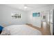 Bedroom with a ceiling fan, mounted tv, and light blue walls at 572 Commonwealth Ln, Sarasota, FL 34242