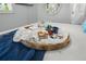 Close up of a breakfast tray on a white bed with baked goods, fruit, and a dark blue blanket at 572 Commonwealth Ln, Sarasota, FL 34242