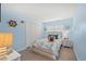 Coastal bedroom with blue walls, white closet, and nautical themed decor at 572 Commonwealth Ln, Sarasota, FL 34242