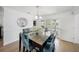 The dining room showcases a stylish glass table, seating for six, and access to a relaxing outdoor view at 572 Commonwealth Ln, Sarasota, FL 34242