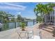 Waterfront dock with seating and canal views offer a relaxing outdoor experience at 572 Commonwealth Ln, Sarasota, FL 34242