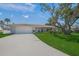 Inviting home featuring a well-manicured lawn and a pristine white exterior at 572 Commonwealth Ln, Sarasota, FL 34242