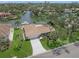 Lovely exterior showcasing boat dock, tile roof, and lush landscaping in this waterfront home at 572 Commonwealth Ln, Sarasota, FL 34242