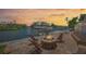Waterfront property features a cozy brick fire pit and boat dock, perfect for outdoor entertaining at 572 Commonwealth Ln, Sarasota, FL 34242