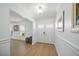 Bright foyer featuring elegant flooring, fresh white trim, and stylish decor at 572 Commonwealth Ln, Sarasota, FL 34242