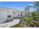 Charming home featuring a welcoming front porch and colorful landscaping at 572 Commonwealth Ln, Sarasota, FL 34242