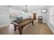 Spacious game room features a classic pool table and access to dining and outdoor space, perfect for entertaining at 572 Commonwealth Ln, Sarasota, FL 34242