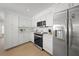 Modern kitchen featuring all-white cabinets, stainless steel appliances, and sleek countertops at 572 Commonwealth Ln, Sarasota, FL 34242
