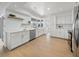 Bright and spacious kitchen featuring white cabinets, stainless steel appliances, and modern finishes at 572 Commonwealth Ln, Sarasota, FL 34242