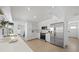 Modern kitchen featuring all-white cabinets, stainless steel appliances, and sleek countertops at 572 Commonwealth Ln, Sarasota, FL 34242