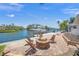 Waterfront patio featuring a cozy fire pit, ideal for evening relaxation and entertaining at 572 Commonwealth Ln, Sarasota, FL 34242