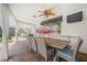 Covered patio has an outdoor dining table beside views of the pool and backyard at 572 Commonwealth Ln, Sarasota, FL 34242