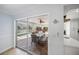 Covered patio with a dining table that sits beside sliding glass doors and an outdoor pool at 572 Commonwealth Ln, Sarasota, FL 34242