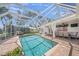 Large screened pool with dining area offers the perfect outdoor retreat at 572 Commonwealth Ln, Sarasota, FL 34242