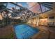 A screened outdoor pool area features poolside furniture and access to an outdoor dining area at 572 Commonwealth Ln, Sarasota, FL 34242