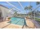 Relaxing screened pool with an inviting sun lounger and picturesque waterway views at 572 Commonwealth Ln, Sarasota, FL 34242