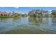 Waterfront view of luxury homes with lush landscaping along a tranquil canal at 572 Commonwealth Ln, Sarasota, FL 34242