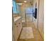 This bathroom features a pristine white vanity with sink and a glass-enclosed shower stall at 600 Mirabella Cir # 201, Venice, FL 34292