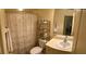 This bathroom features a vanity with sink and a toilet, complemented by a decorative shower curtain at 600 Mirabella Cir # 201, Venice, FL 34292