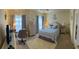 Serene bedroom retreat with soft decor, window and a cozy atmosphere perfect for relaxation and rest at 600 Mirabella Cir # 201, Venice, FL 34292