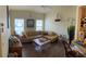 Comfortable living room with a large sectional sofa, decorative elements, and abundant natural light at 600 Mirabella Cir # 201, Venice, FL 34292