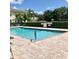 The community pool area is surrounded by lush landscaping, offering a serene and private retreat at 600 Mirabella Cir # 201, Venice, FL 34292