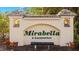 Attractive entrance sign for Mirabella, A Condominium, set amidst lush greenery and manicured landscaping at 600 Mirabella Cir # 201, Venice, FL 34292