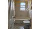 Bathroom featuring a tub/shower combination and tiled walls at 6006 Midnight Pass Rd # 48, Sarasota, FL 34242