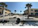 Well-maintained condo exterior with lush landscaping near beach access at 6006 Midnight Pass Rd # 48, Sarasota, FL 34242