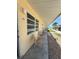 Exterior view of the condo units with chairs outside Unit 48 at 6006 Midnight Pass Rd # 48, Sarasota, FL 34242