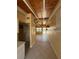 Hallway with tiled floors, wood plank ceiling, and view into living area at 6006 Midnight Pass Rd # 48, Sarasota, FL 34242