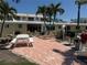 Outdoor patio area with seating and grill at the condo community at 6006 Midnight Pass Rd # 48, Sarasota, FL 34242
