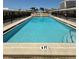 Community pool surrounded by a fence at 6006 Midnight Pass Rd # 48, Sarasota, FL 34242