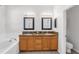 Bright bathroom featuring dual sinks, granite countertops, a soaking tub, and a toilet at 6032 36Th E Ct, Ellenton, FL 34222