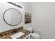 Half bathroom features a granite countertop, stylish mirror, and modern fixtures at 6032 36Th E Ct, Ellenton, FL 34222