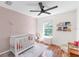 Bright Bedroom featuring a crib, comfortable seating, a ceiling fan, and a view of the outdoors at 6032 36Th E Ct, Ellenton, FL 34222