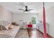Bright bedroom decorated with pink accents features a ceiling fan, a desk, and a comfortable bed at 6032 36Th E Ct, Ellenton, FL 34222