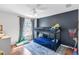 Bright bedroom with a bunk bed, ceiling fan, and large window with lots of natural light at 6032 36Th E Ct, Ellenton, FL 34222