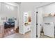 View of hallway featuring half bathroom, laundry room, and living room at 6032 36Th E Ct, Ellenton, FL 34222