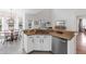 Eat-in kitchen showcasing granite countertops, white cabinets, stainless steel appliances, and a dining table area at 6032 36Th E Ct, Ellenton, FL 34222