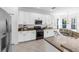 Modern kitchen with white cabinets, granite countertops, stainless steel appliances, and ample counter space at 6032 36Th E Ct, Ellenton, FL 34222