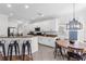 Modern kitchen with white cabinets, stainless steel appliances, granite countertops, and an adjacent dining area at 6032 36Th E Ct, Ellenton, FL 34222