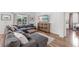 Comfortable living room featuring wood floors, a large sectional couch, entertainment center and an adjacent office space at 6032 36Th E Ct, Ellenton, FL 34222