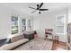 Bright room featuring modern ceiling fan, sofa, rug, and large windows at 6032 36Th E Ct, Ellenton, FL 34222