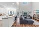 Spacious living room features hardwood floors, a large kitchen, and modern furniture at 6032 36Th E Ct, Ellenton, FL 34222